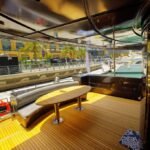 Outdoor seating on lower deck of 95 ft yacht, offering comfort for group yacht hire in Dubai