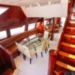 Staircase leading to upper deck, showcasing the elegant interior of Dubai's 95 ft yacht
