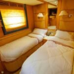 Twin single bed cabin in Dubai's 95 ft yacht, perfect for family-friendly yacht charters