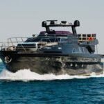 Elegant 95 ft yacht front view cruising in Dubai, perfect for luxury group charters