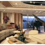 180 ft Ultra Luxury Yacht 17 Guest 16 Elegant interior of the yacht featuring a grand piano, enhancing the Ultra Luxury Yacht Rental Dubai experience