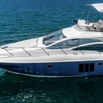 Side view of the sleek 48 ft motor yacht, showcasing its grandeur and style, ideal for boutique yacht charters in Dubai